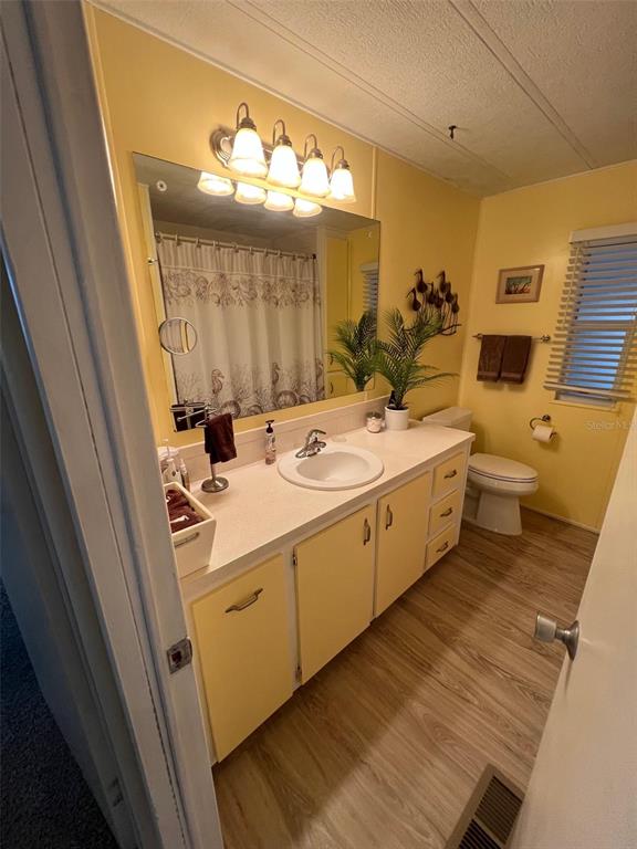 52 Frangipani Circle Largo, FL 33770 - Photo 31 of 33 a bathroom with a sink a toilet and mirror