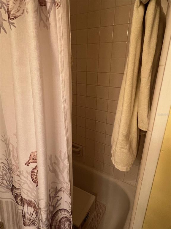 52 Frangipani Circle Largo, FL 33770 - Photo 33 of 33 a bathroom with a bathtub and shower curtain