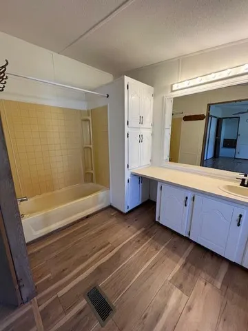 a bathroom with a sink mirror vanity and toilet