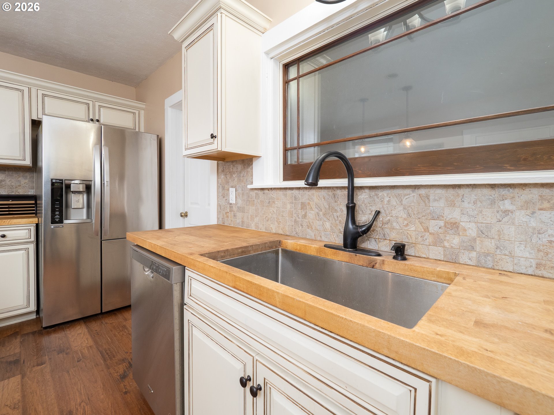 336 North 5th Street Carlton, OR 97111 - Photo 11 of 48 a view kitchen with stainless steel appliances granite countertop a sink and a refrigerator