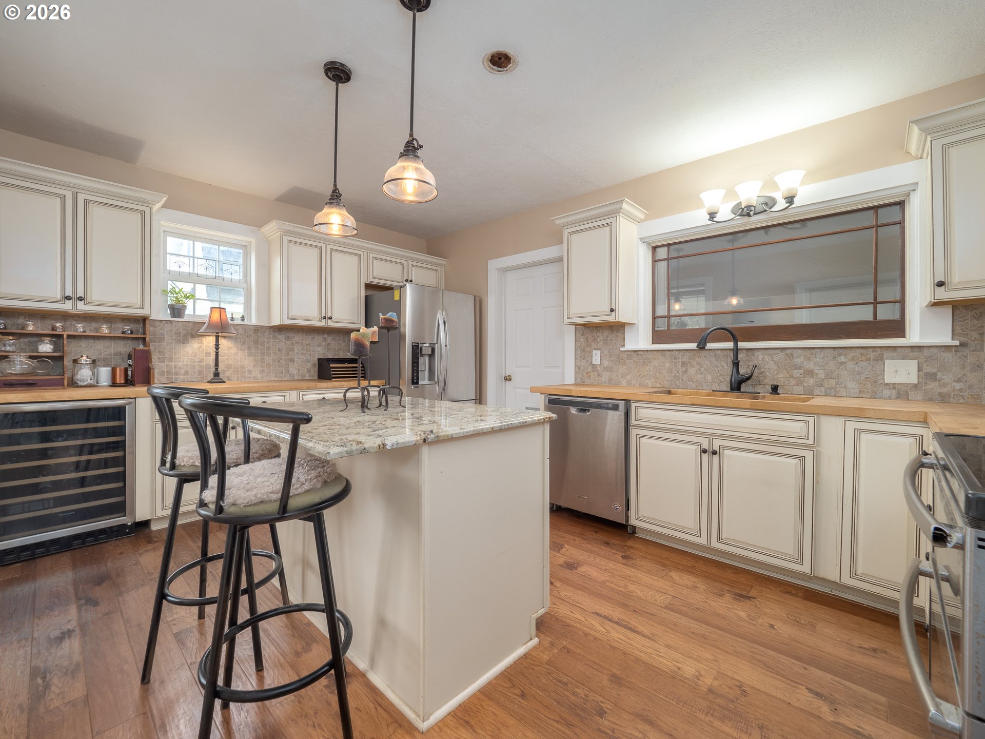 336 North 5th Street Carlton, OR 97111 - Photo 5 of 48 a kitchen with stainless steel appliances a table chairs refrigerator and sink