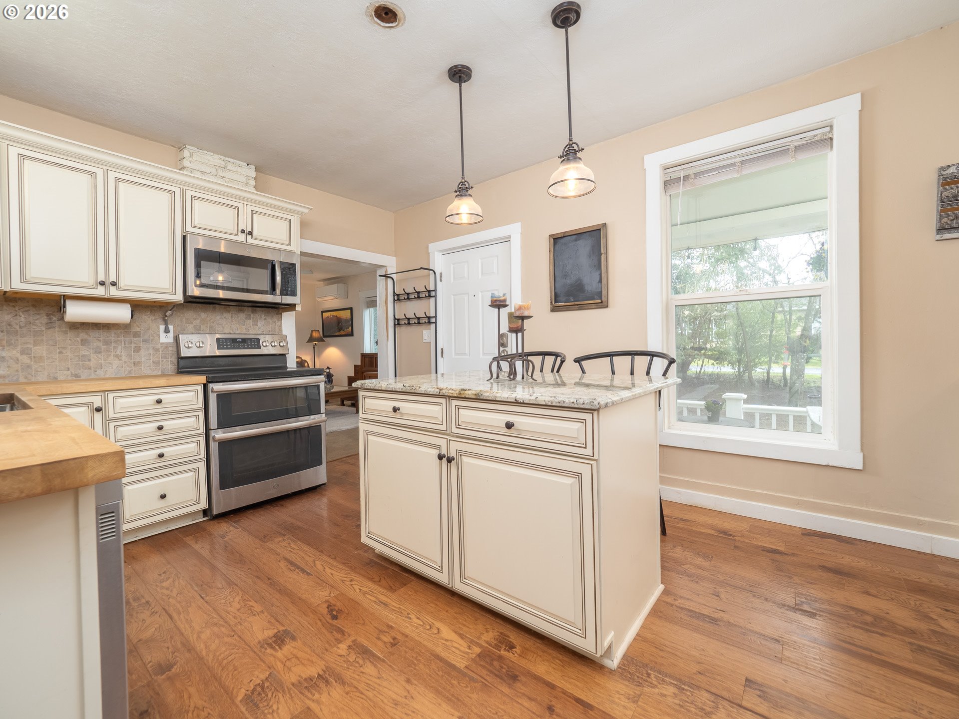 336 North 5th Street Carlton, OR 97111 - Photo 8 of 48 a kitchen with stainless steel appliances granite countertop a stove a sink and a microwave