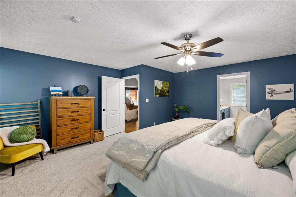 128 Byrom Road Senoia, GA 30276 - Photo 27 of 83 a bedroom with a bed and a ceiling fan
