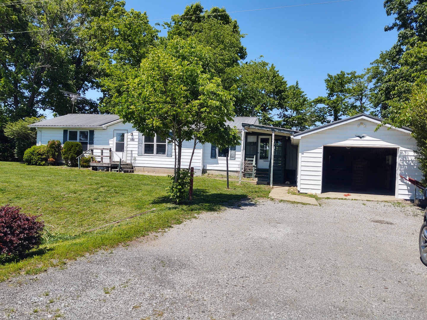 1045 Ozark Road Ozark, IL 62972 - Photo 3 of 17 a front view of a house with a yard and potted plants