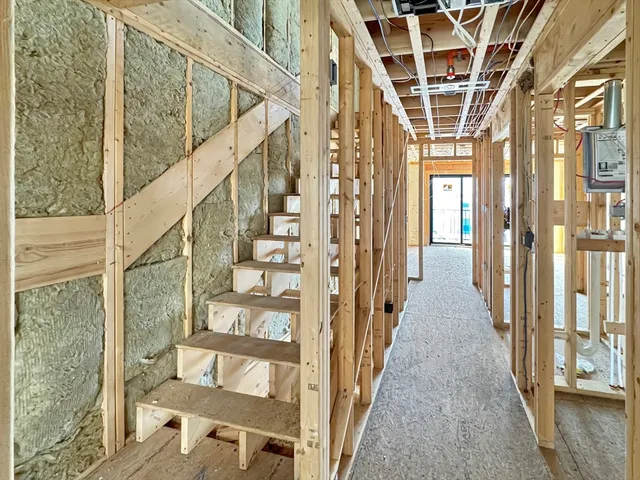 a view of entryway with wooden floor and windows