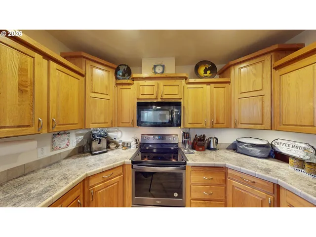 a kitchen with stainless steel appliances a stove a sink and a microwave