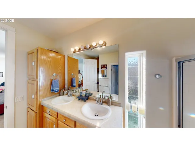 a bathroom with a sink double vanity and a mirror