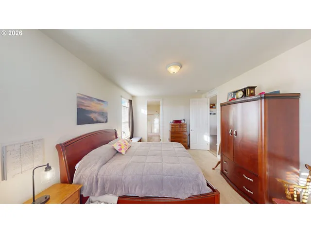 a living room with a bed furniture and a flat screen tv