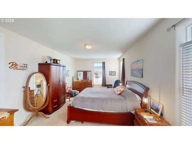 a living room with furniture a mirror and wooden floor