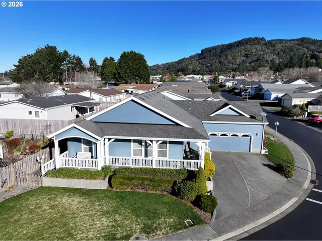 an aerial view of residential houses with yard