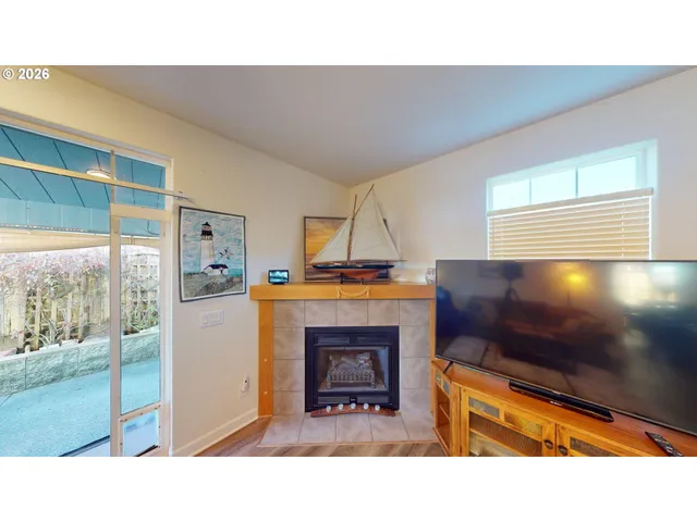 a living room with a fireplace furniture and a flat screen tv