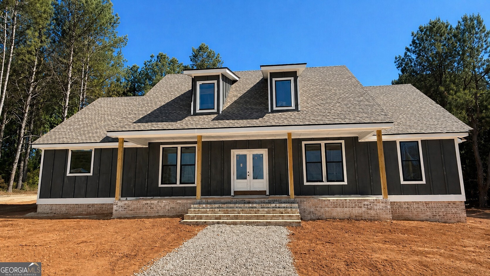 a front view of a house with a garden