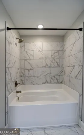 a bathroom with a shower and a bath tub
