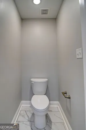a white toilet sitting next to a white sink