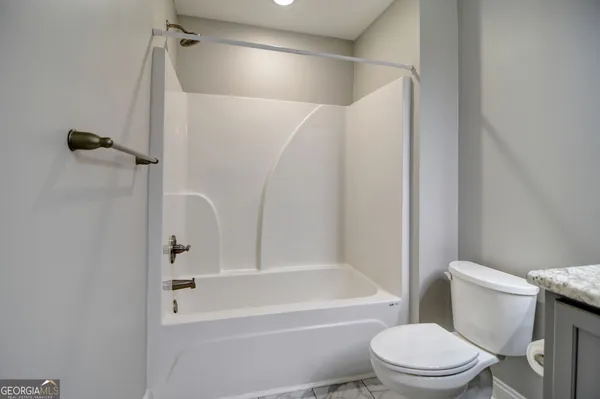 a bathroom with a toilet and a bathtub
