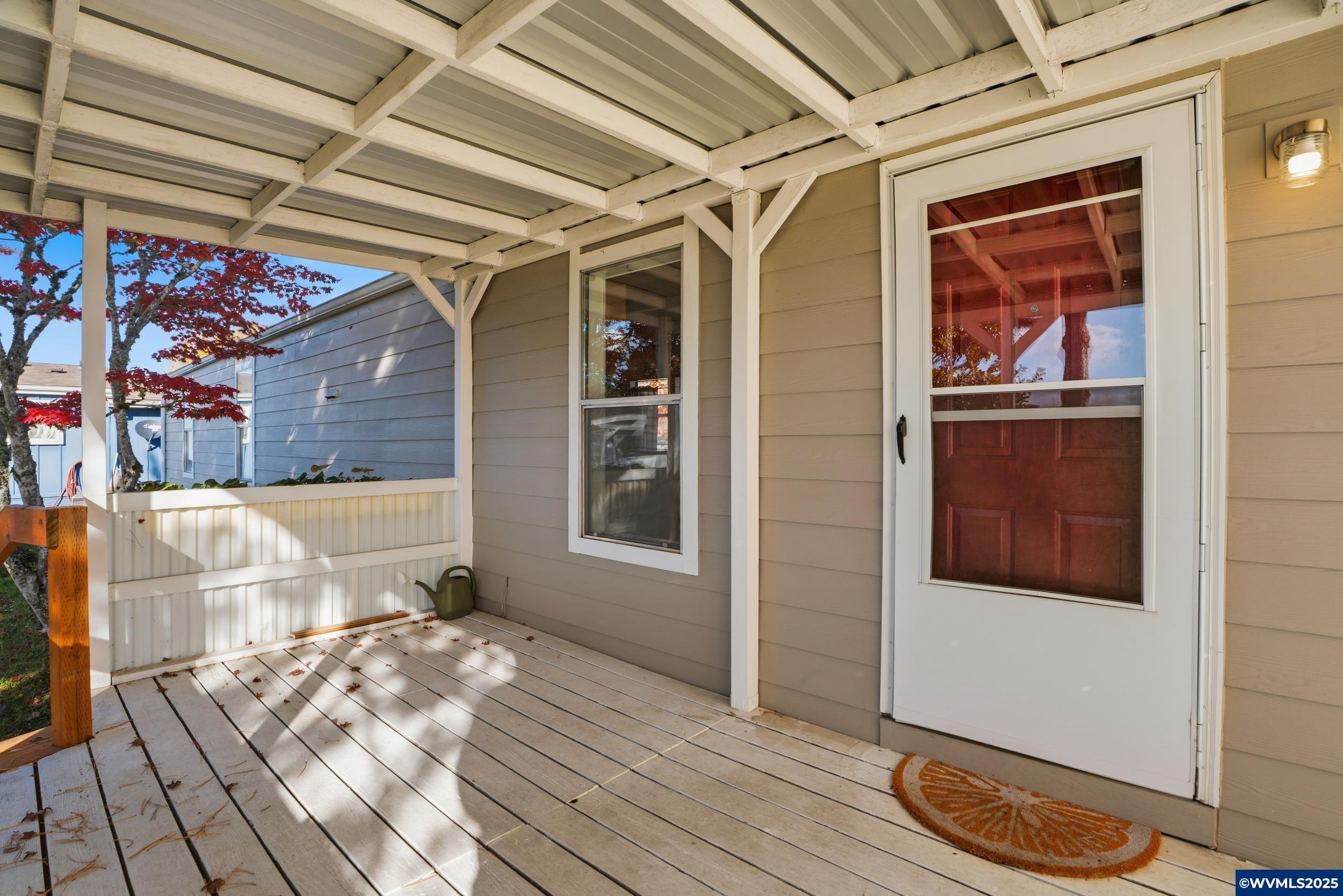 277 Edwards Road, Unit 145 Monmouth, OR 97361 - Photo 1 of 47 a view of a porch with wooden floor and a sink