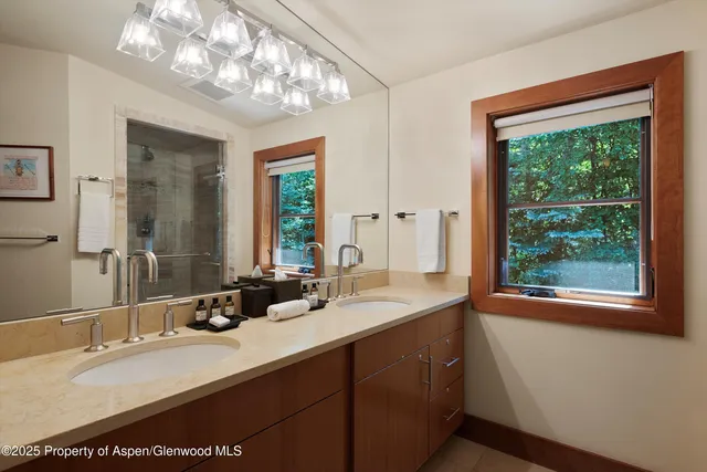 a bathroom with a double vanity sink and a mirror