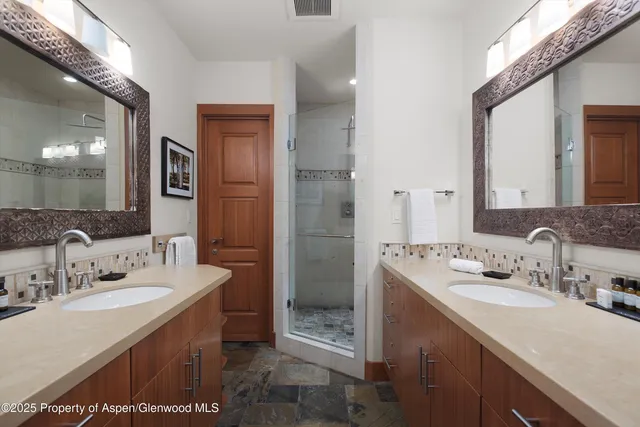 a bathroom with a sink double vanity and a mirror