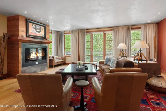 a room with furniture a large window and a chandelier