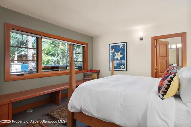 a bedroom with a large bed and a large window