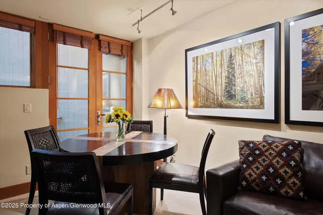 a view of a dining room with furniture and window