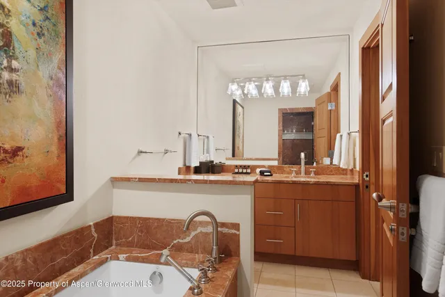 a bathroom with a sink a mirror and a bathtub