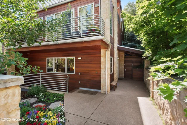 a view of a house with a yard and a potted plant