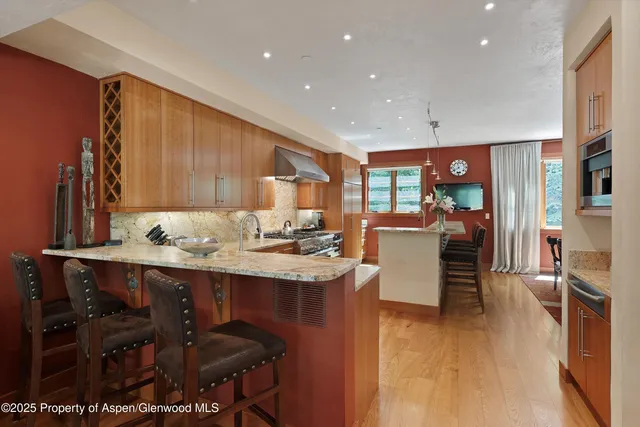 a kitchen with a sink cabinets and wooden floor