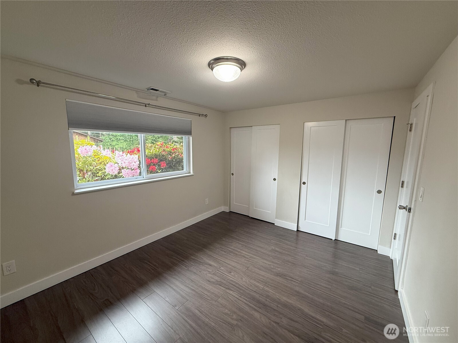8820 Prentice Avenue Gig Harbor, WA 98332 - Photo 10 of 13 a view of an empty room with wooden floor and a window