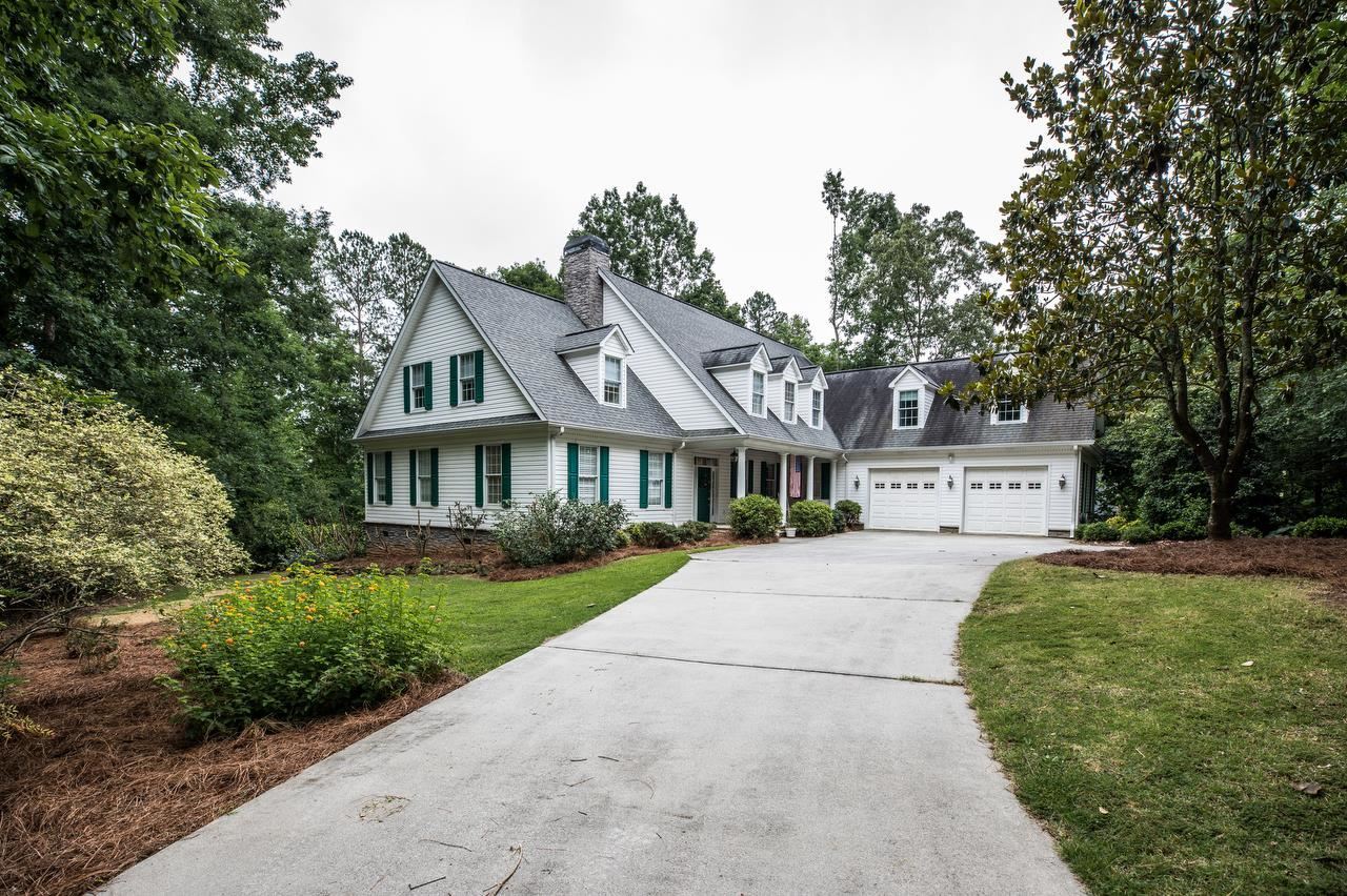 7342 South Mitchell Court Villa Rica, GA 30180 - Photo 1 of 1 a front view of a house with a yard and garage