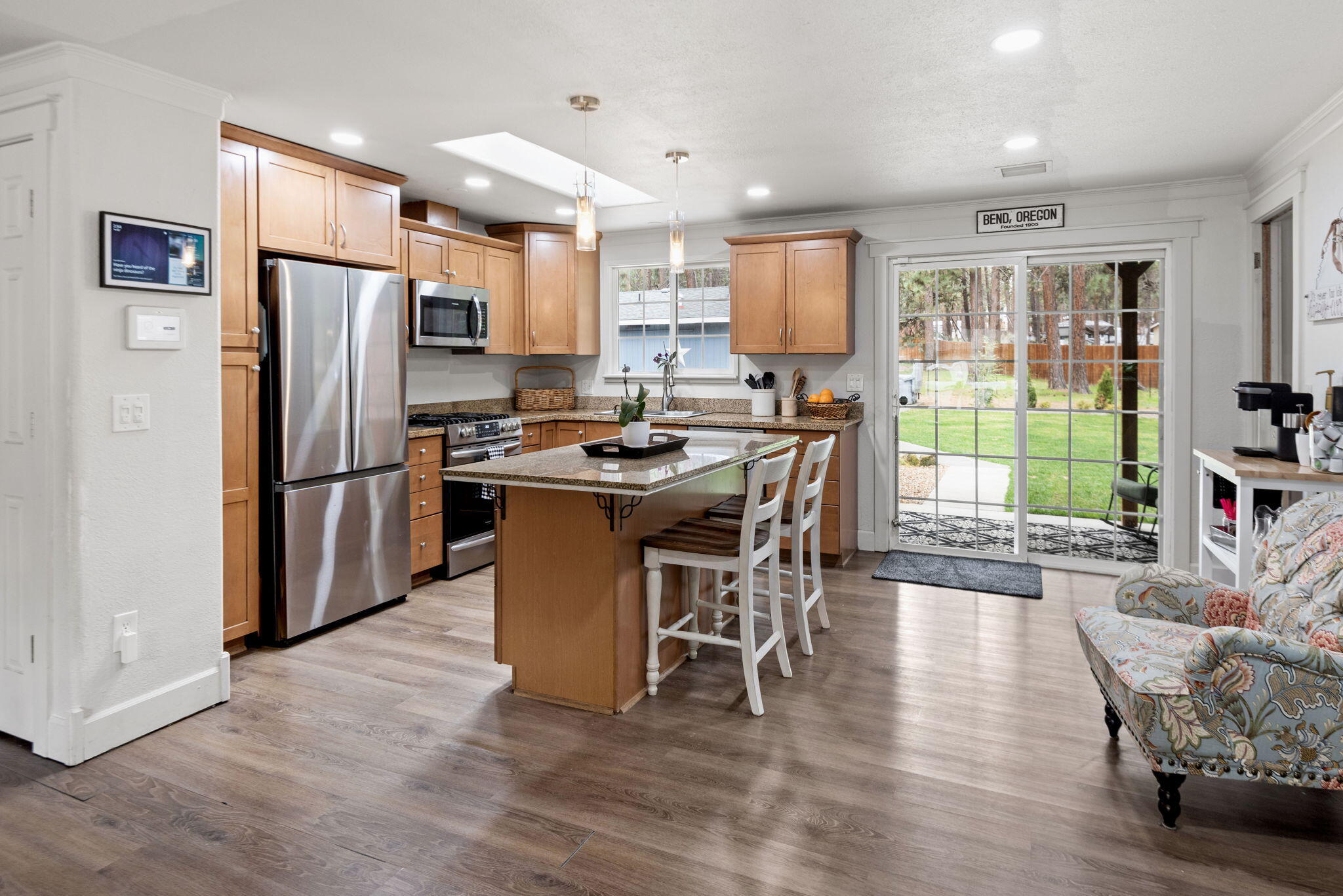 19115 Kiowa Road Bend, OR 97702 - Photo 6 of 35 a kitchen with stainless steel appliances granite countertop a stove refrigerator a dining table and chairs