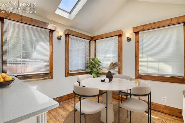 a view of a dining room with furniture and window