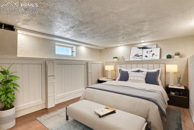 a bedroom with a bed and a potted plant