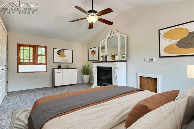 a spacious bedroom with a bed and ceiling fan