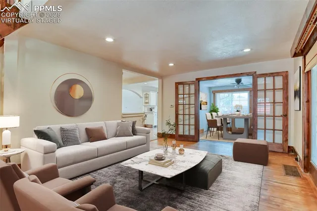 a living room with furniture and wooden floor