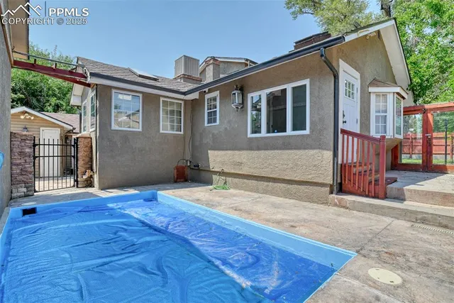 a front view of a house with a yard table and chairs