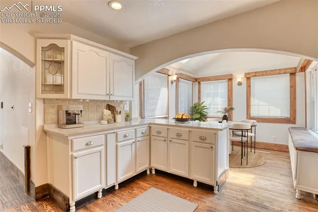 a kitchen with sink cabinets and wooden floor