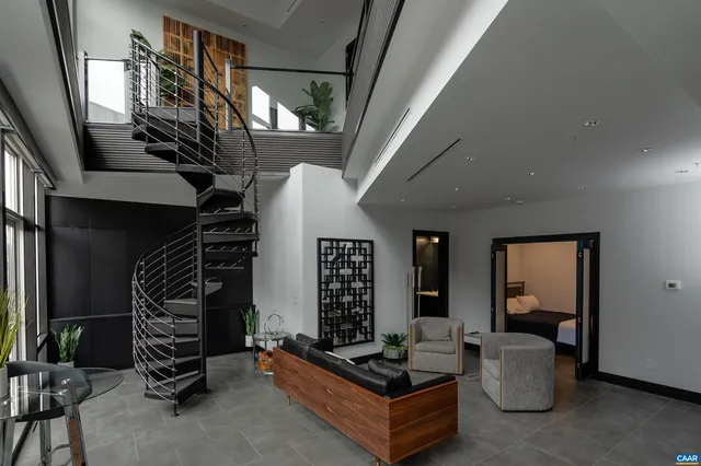a living room with furniture and a staircase