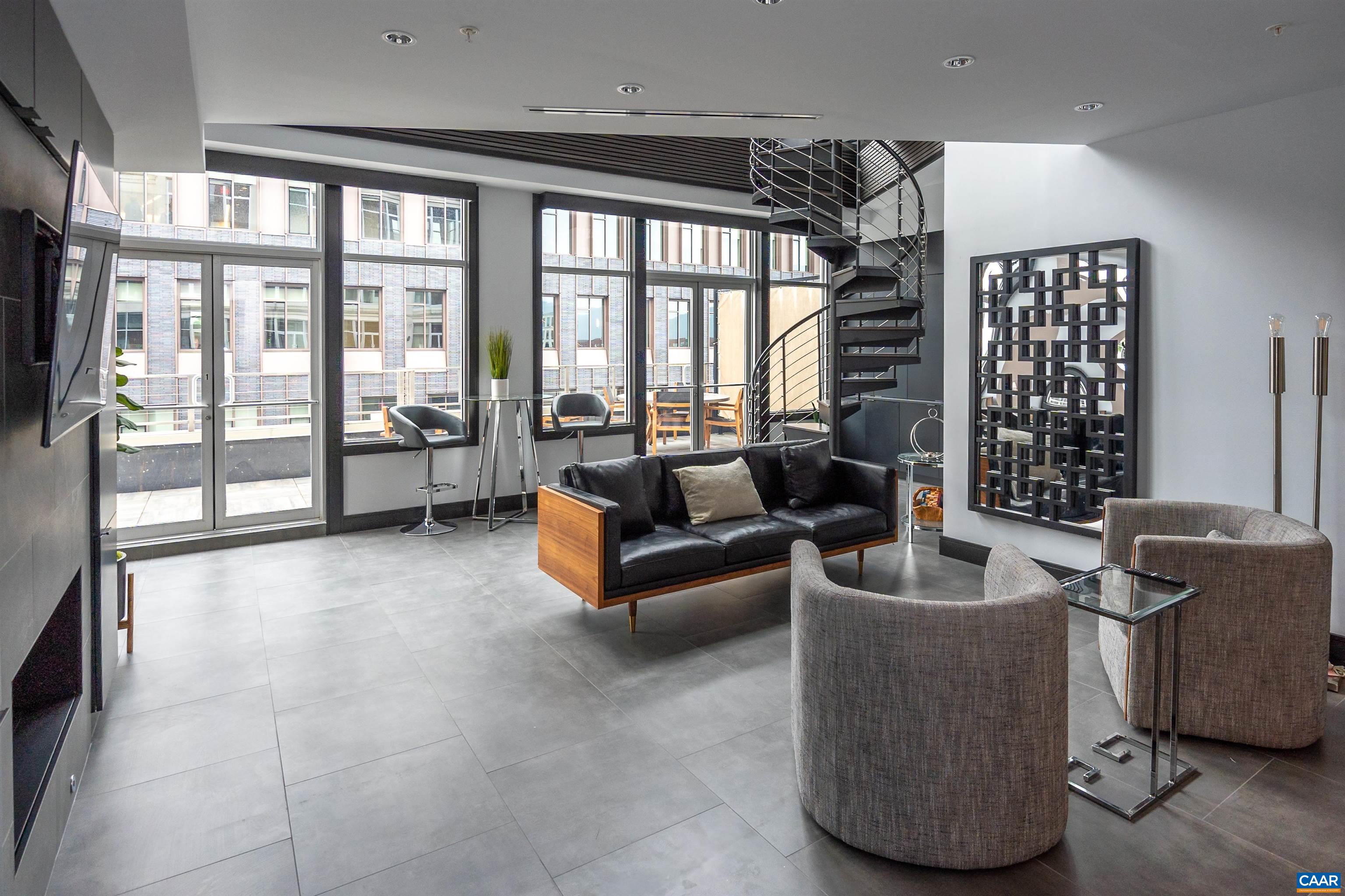 218 West Water Street, Unit 600 Charlottesville, VA 22902 - Photo 12 of 40 a living room with furniture and large windows