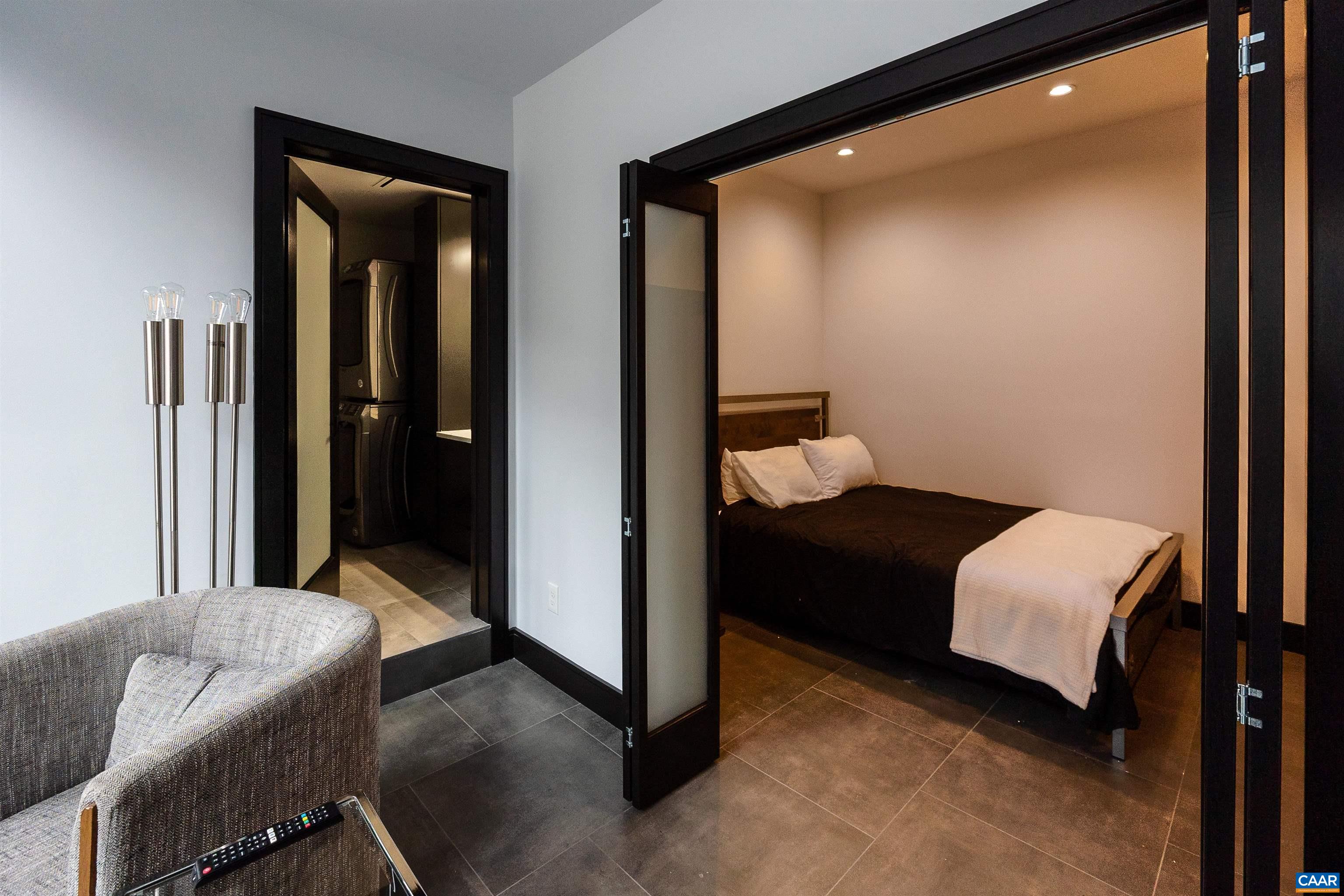 218 West Water Street, Unit 600 Charlottesville, VA 22902 - Photo 17 of 40 a bedroom with a bed and a couch