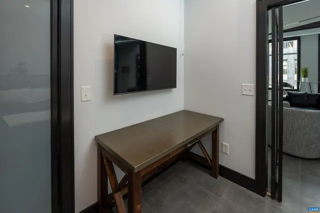 a living room with a table and a flat screen tv