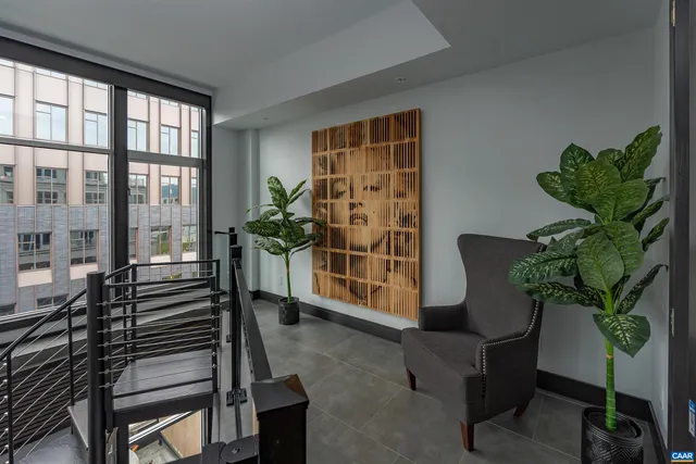 a living room with furniture and a potted plant