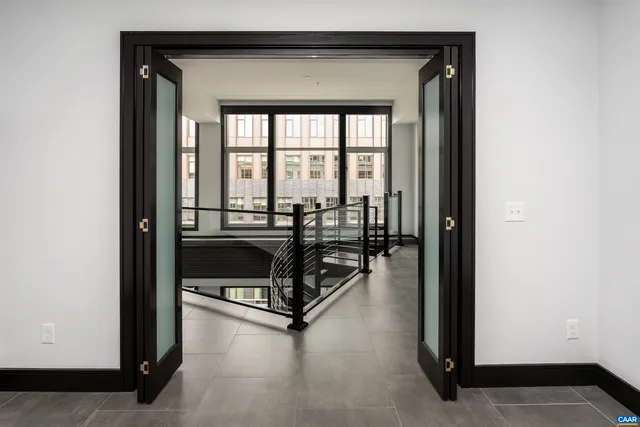 a living room with furniture and a floor to ceiling window