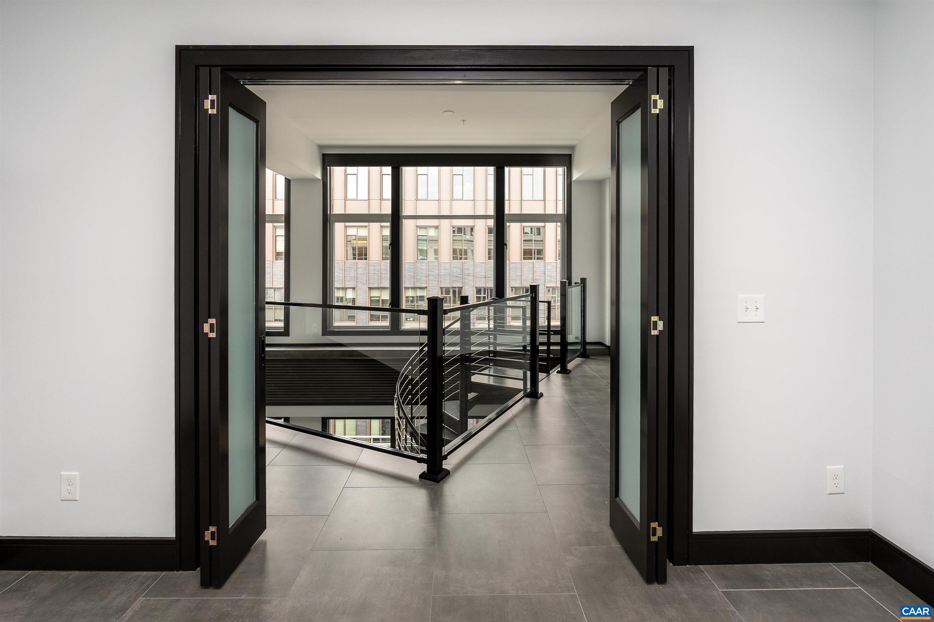 218 West Water Street, Unit 600 Charlottesville, VA 22902 - Photo 27 of 40 a living room with furniture and a floor to ceiling window