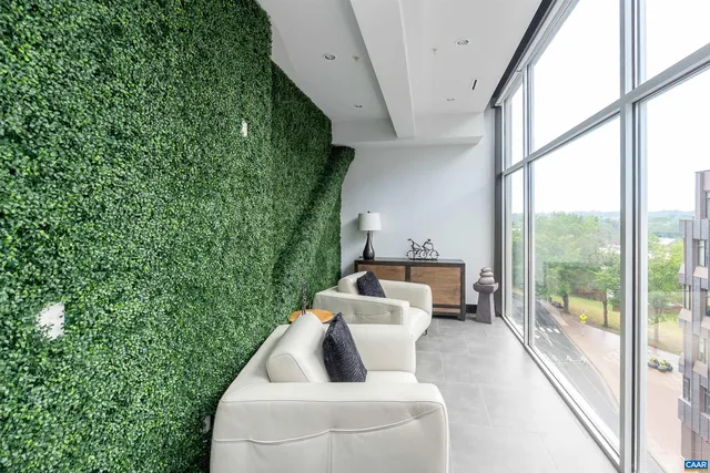 a living room with furniture and a floor to ceiling window