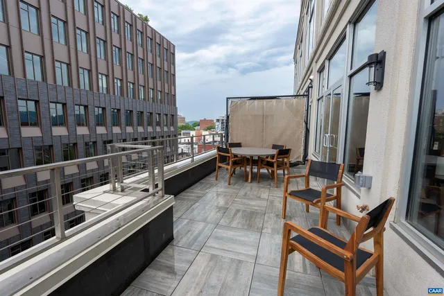 a balcony with chairs and a stove