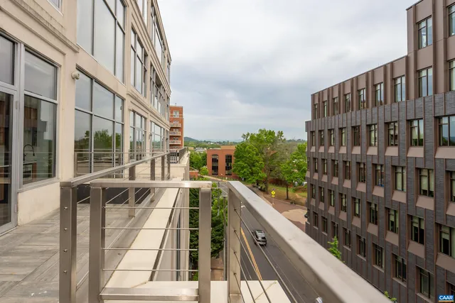 a view of balcony with a couple of large trees