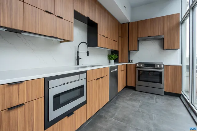 a kitchen with a sink stove and cabinets
