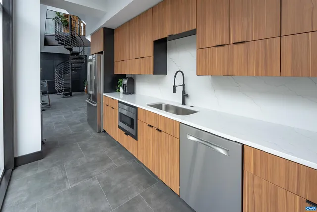 a kitchen with stainless steel appliances a sink stove and cabinets