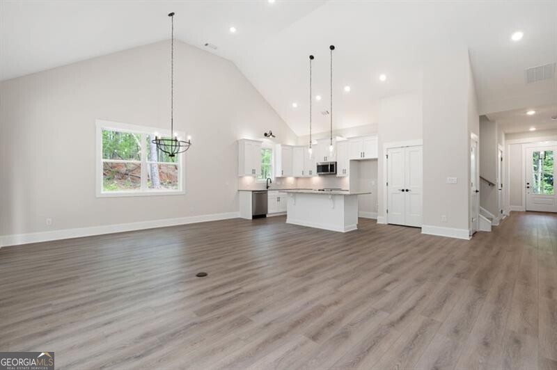 110 Doris Path Dallas, GA 30157 - Photo 16 of 35 a view of a kitchen with a fridge and wooden floor